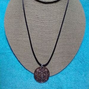 Bronze color black cord intricate design coin necklace